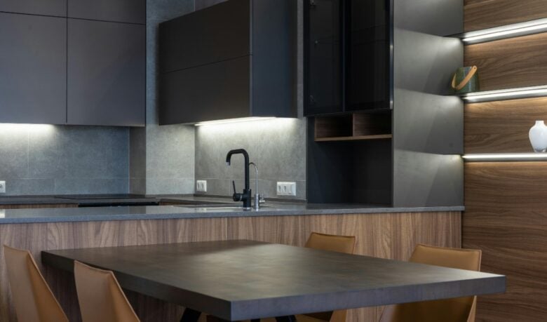 Trend arredo 2026: grigio antracite, pietra naturale e vetro fumé ridisegnano lo spazio della Cucina